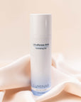 Luminar UltraRenew AHA Exfoliator Gel bottle on elegantly draped peach fabric, evoking gentle exfoliation and renewal.