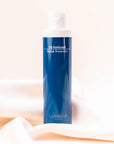 Luminar O3 Sunguard bottle placed on softly draped peach fabric, representing protective skincare.