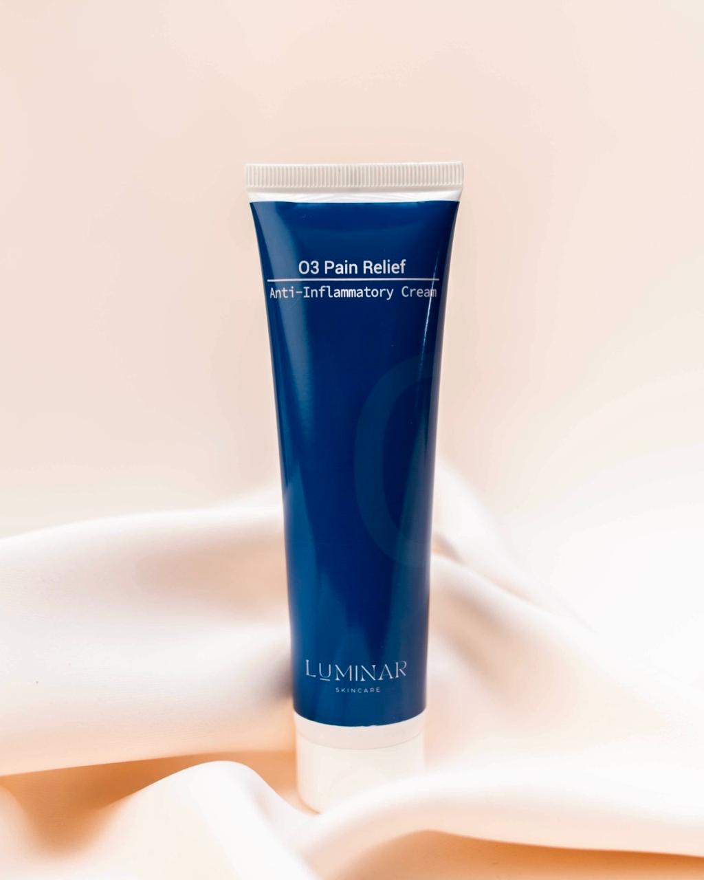 Luminar O3 Pain Relief product placed on soft peach fabric, representing soothing and targeted relief.