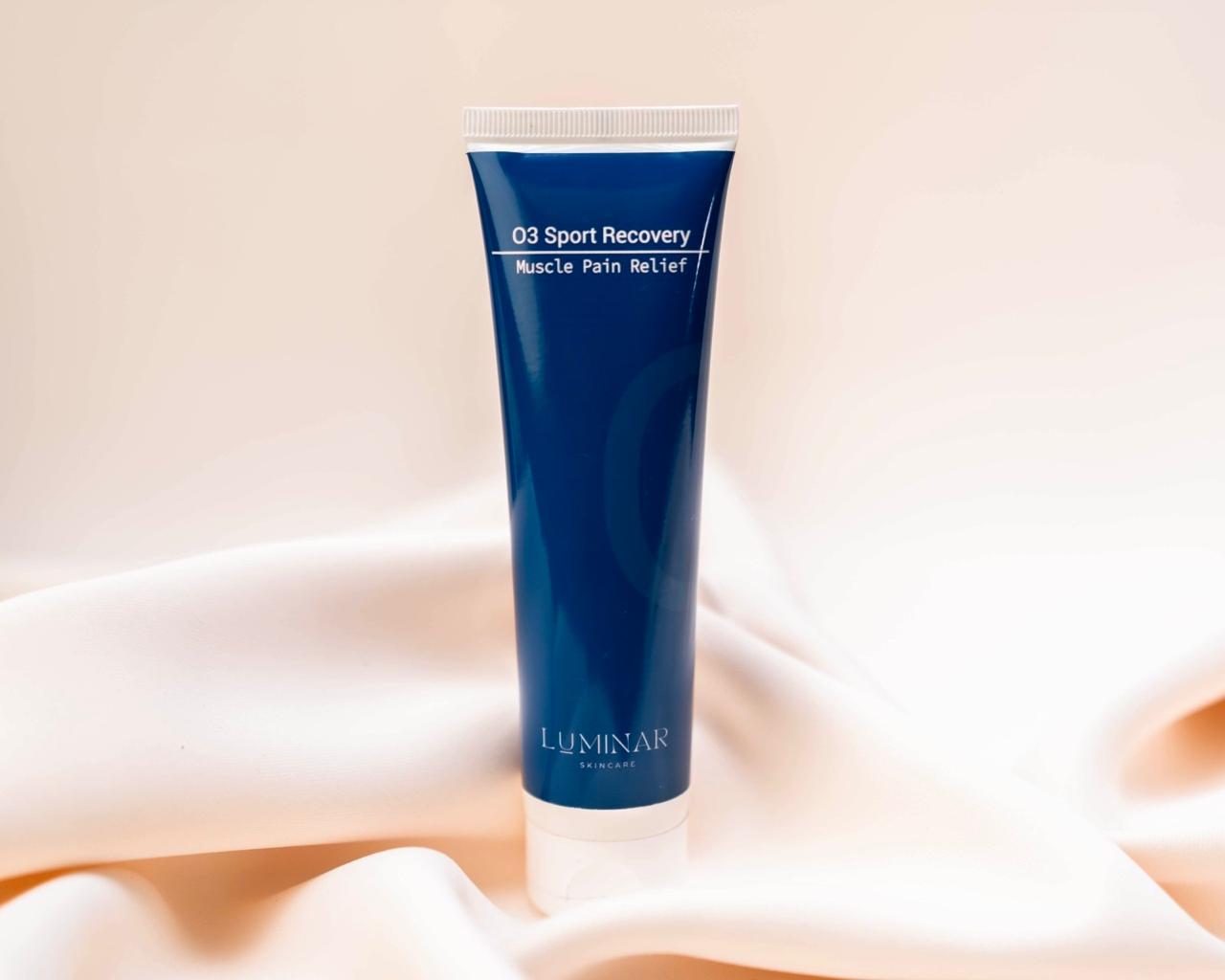 Luminar O3 Sport Recovery bottle nestled on peach fabric, symbolizing post-workout restoration.