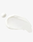 Creamy white swatch of O3 Face Cleanser with a small dollop beside it, showing the cleanser’s smooth skincare texture on a white background.